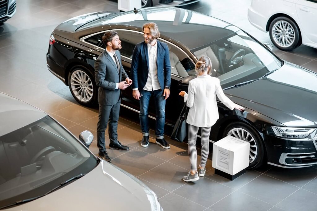 business couple with salesperson in the car showro 2025 03 16 03 18 56 utc