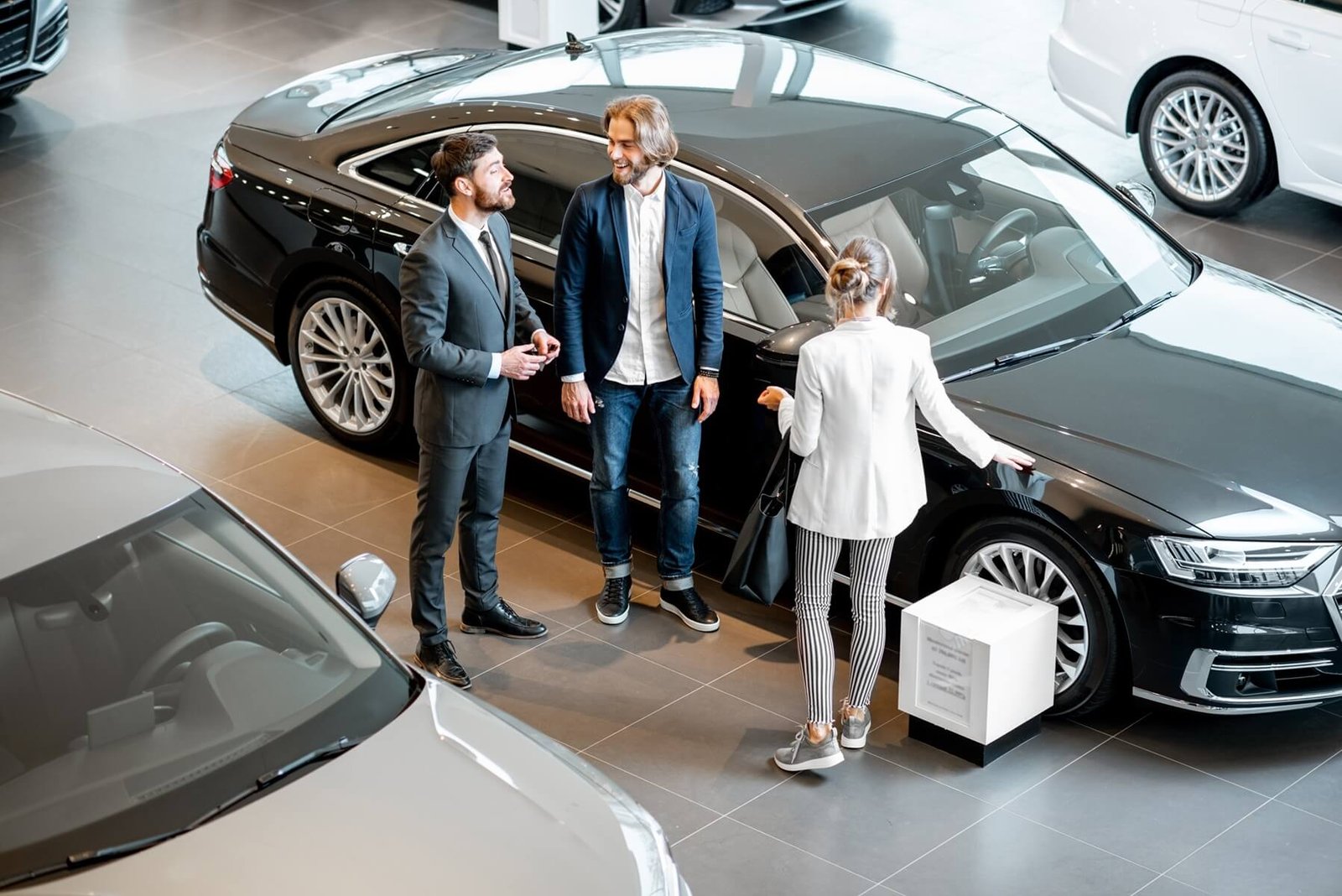 business couple with salesperson in the car showro 2025 03 16 03 18 56 utc