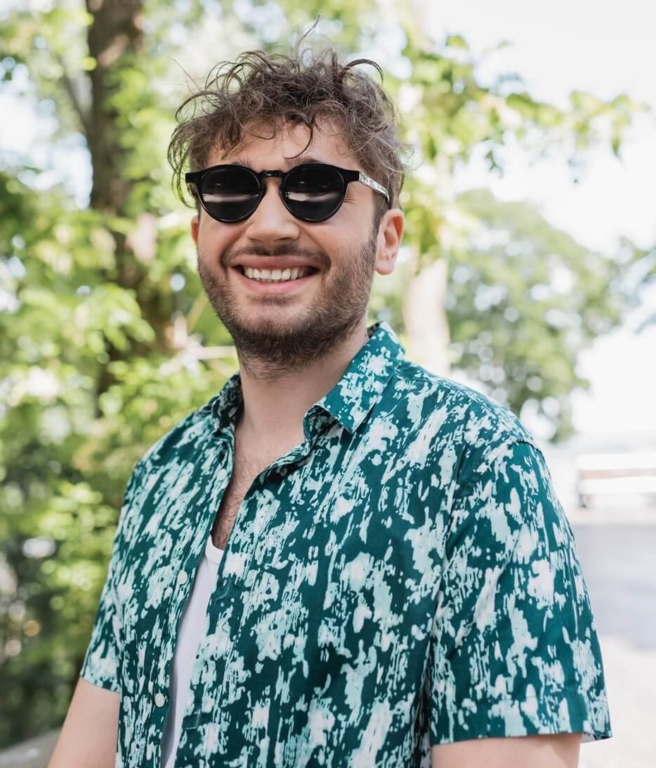cheerful man in sunglasses and shirt standing in s 2024 11 14 14 40 50 utc e1742962813651